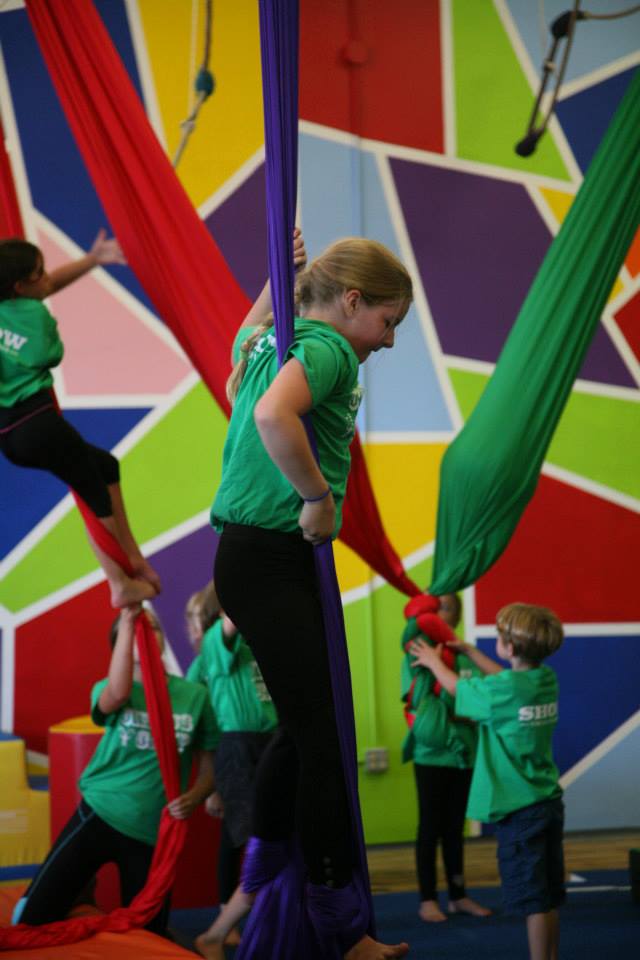 Camper standing in a fabric loop at SHOW Circus Studio in Easthampton, Massachusetts