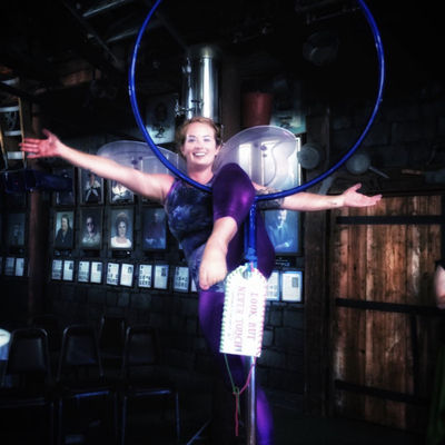 Practitioner from SHOW Circus Studio in Easthampton, Massachusetts, hanging from a lyra.