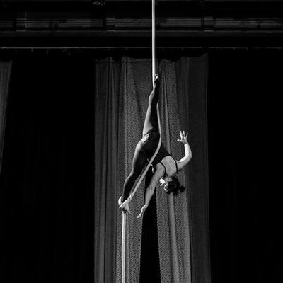 Performer from SHOW Circus Studio in Easthampton, Massachusetts, doing a vertical split while hanging from a rope.