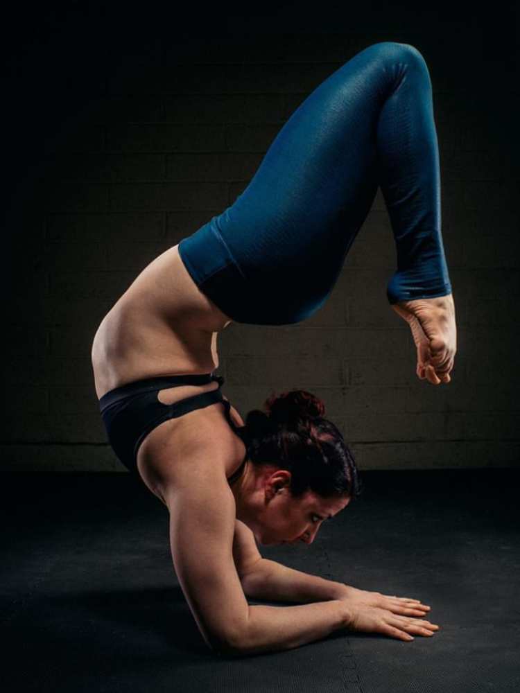 Performer doing a back-bend while self-supporting on forearms at SHOW Circus Studio in Easthampton, Massachusetts